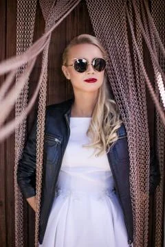 Fashionable bride with leather jacket and sunglasses. Outdoor portrait Stock Photos