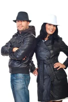 Fashionable couple in leather coats and hats Stock Photos