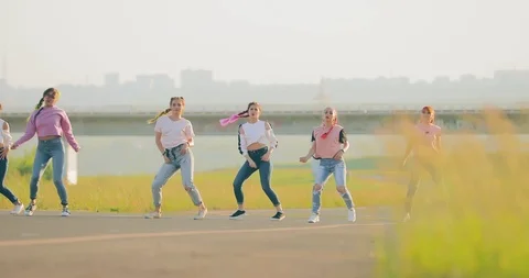 Fashionable dance synchronously dancing hip-hop at the bridge in the summer Stock Footage 111228073