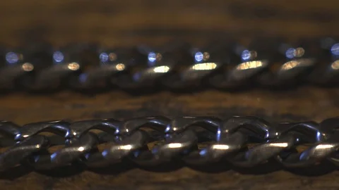 Fashionable Interlocking Silver Cuban Chain On The Wooden Table. -closeup Stock Footage 128332408