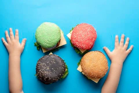 Fashionable set of multi-colored small hamburgers. Vegetarian and meat burger Stock Photos