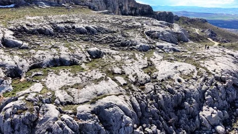 Fast Aerial Approach Toward Dramatic Rock Caves Over Mountain Lake Stock Footage 342180570