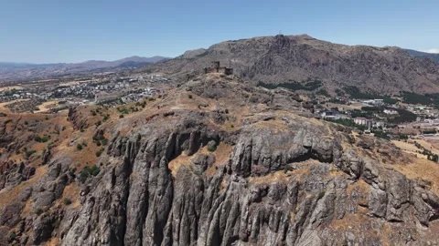 Fast Aerial Flight Toward Ancient Cliff Fortress Across Dramatic Rock Formations Video stock 339572565
