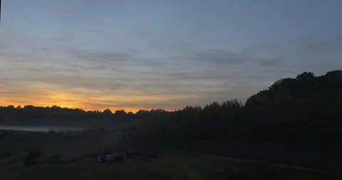 Fast aerial movement through canopy of trees to reveal sunset Stock Footage 102397017
