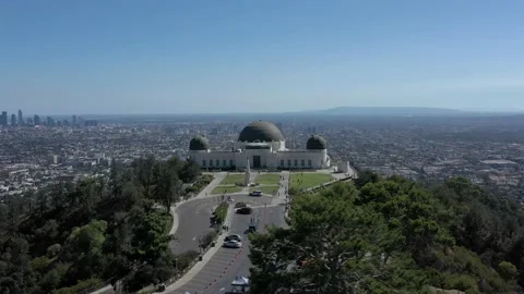 Fast aerial orbit of Griffith Observatory and Los Angeles city skyline far in Stock Footage 212768184