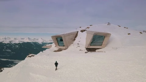 Fast aerial orbit view of a modern gallery/museum on top of a mountain in Stock Footage 123830979