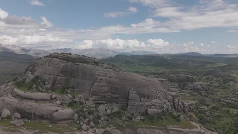 Fast Aerial Pullback From Massive Rock Formation Stock Footage 344689831
