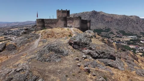 Fast Aerial Pullback Revealing Ancient Hilltop Fortress on Massive Rock Cliffs Stock-Footage 339563131