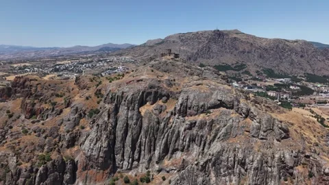 Fast Aerial Pullback Revealing Ancient Hilltop Fortress on Massive Rock Cliffs Stock Footage 339567993