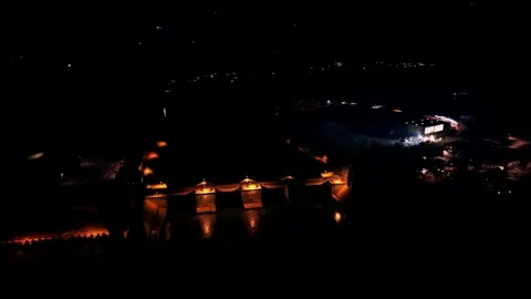 Fast aerial push over illuminated dam at night Stock Footage 328036613