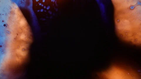 Fast and shaky liquid pattern with orange and dark dye Stock Footage 127715100