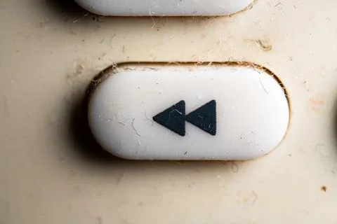 Fast backward icon and button close up of a old Television remote controller Stock Photos