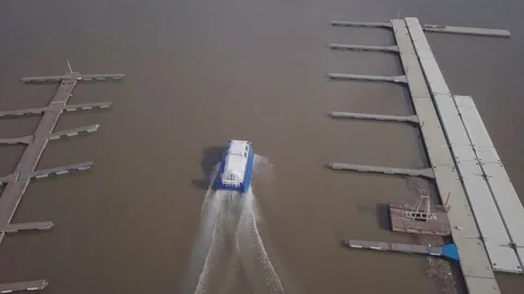 Fast blue white hovercraft sails along river from harbour Stock Footage 155286688