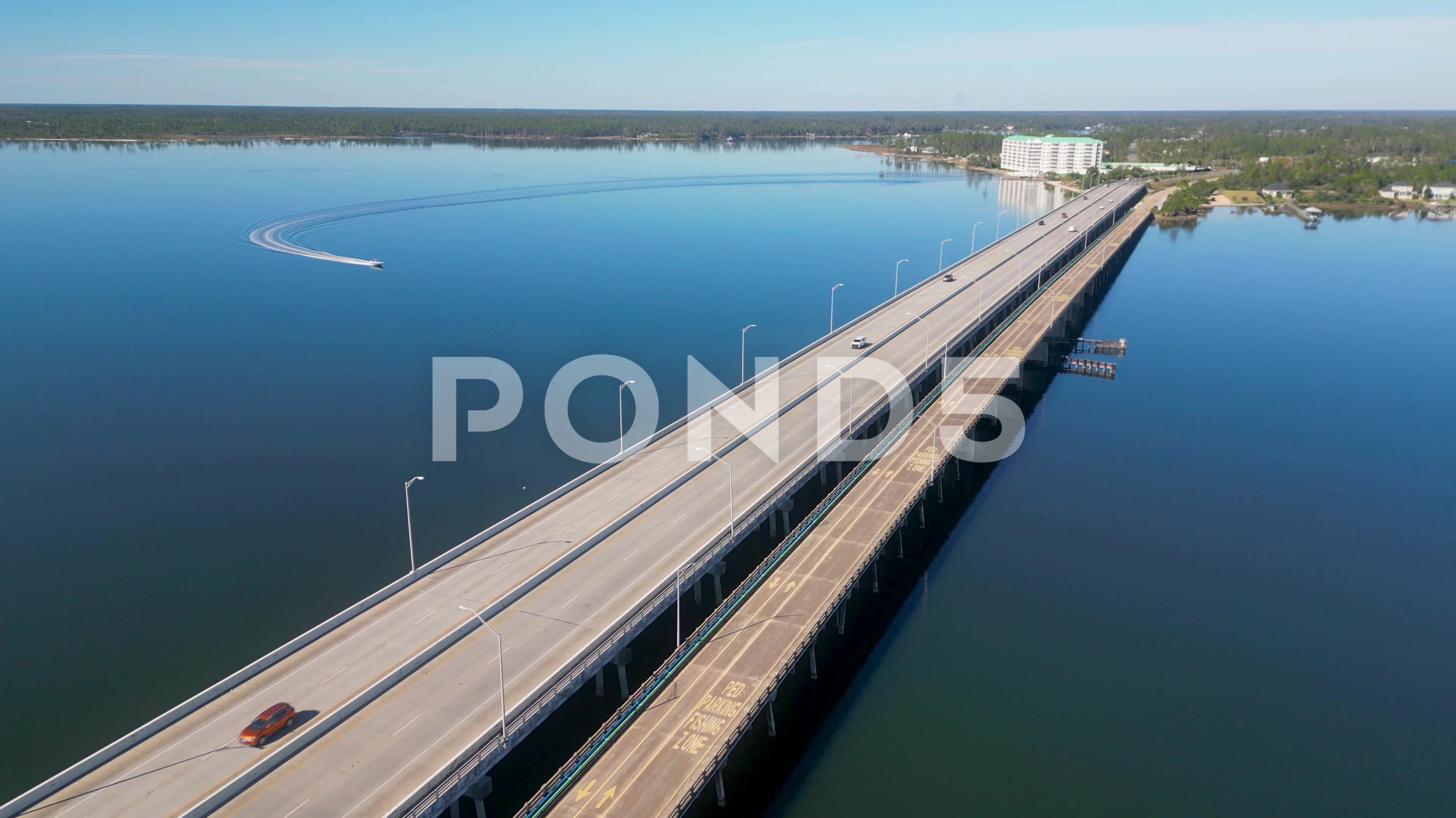 Fast boat crossing under the Bailey Bridge in Lynn Haven Florida.