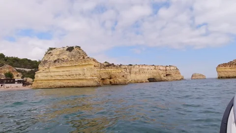 Fast Boat Ride Along Dramatic Golden Limestone Cliffs of Portuguese Coastline Stock-Footage 312251848