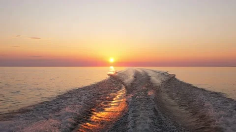 Fast boat rush on flat water, look back to bright sunset and clear sky 스톡 동영상 160403902