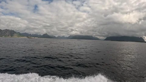 Fast boat water splashes in ocean with dramatic cloudy sky Lofoten Stock-Footage 344047409