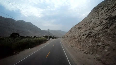 Fast camera of a bus trip on the road  with mountains and blue sky 스톡 동영상 164434578