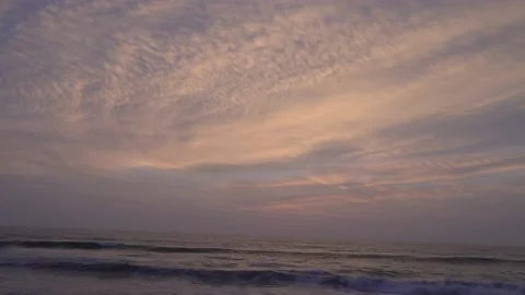 Fast camera of the color change of the clouds on the beach and the waves Stock Footage 145594593
