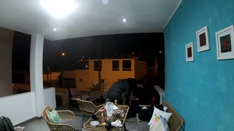 Fast camera of friends having a meeting at a beach house at night in 4K 库存影片 155779044