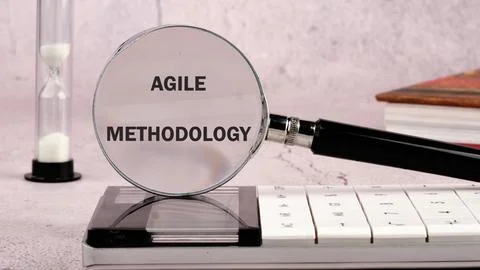 Fast changes concept. AGILE METHODOLOGY on the glass of the magnifying glas.. Stock Photos
