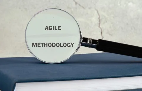 Fast changes concept. AGILE METHODOLOGY on the glass of a magnifying glass on Foto stock