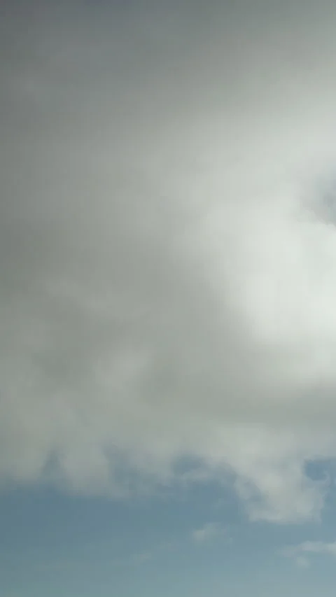 Fast-changing clouds in the sky as a time-lapse video. Vertical video. Stock Footage 239149179
