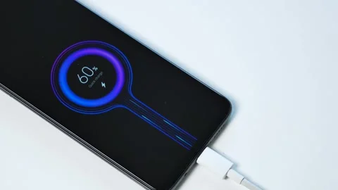 Fast charging smartphone. the charging process is displayed on the screen. Stock Footage 254402575