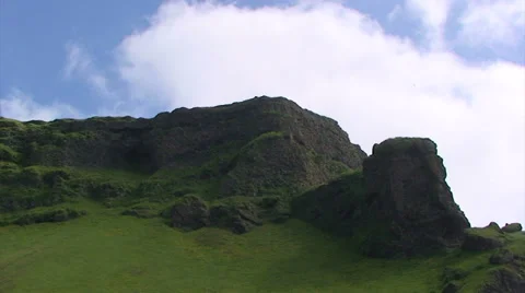 Fast clouds on basaltic rock cliff full of grass, time lapse Stock Footage 37585233