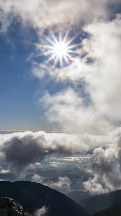 Fast Clouds Moving in Blue Sky with Sun Over Mountains, Vertical Nature Time Stock Footage 320994514