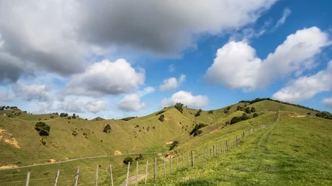 Fast clouds over green rural countryside Time lapse Stock Footage 104248058