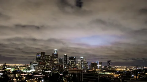 Fast Clouds Sweep Past City, Illuminated by Downtown Timelapse Video stock 60696598