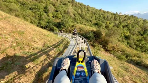 Fast Coaster ride through green mountains near Almaty Kazakhstan in 4K Stock Footage 343376282