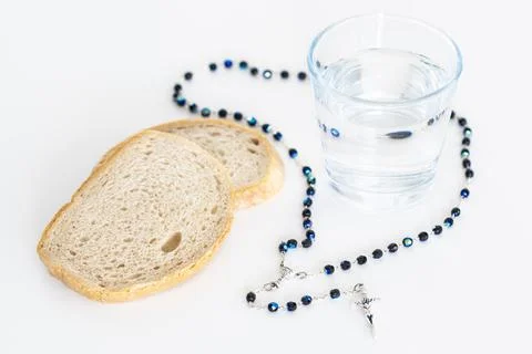 Fast concept with bread water and rosary Foto stock