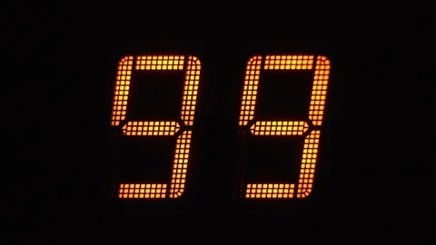 Fast digital countdown in orange numbers on an electronic display from 99 to  Stock Footage 122137971