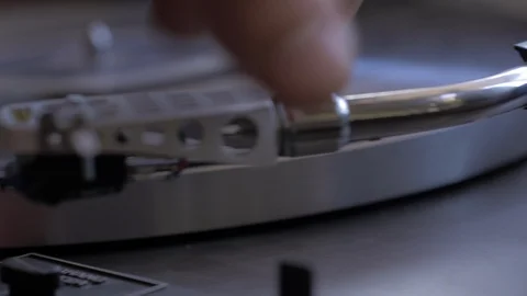 Fast dolly close up shot of needle dropping onto spinning record Stock Footage 88764661