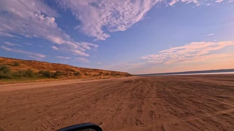 Fast Drive Motion View Past Arid Terrain and Low Horizon Stock-Footage 344818268