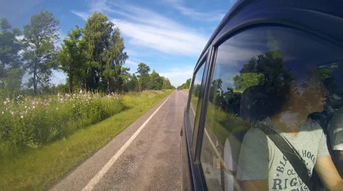 Fast driving a car. The camera is outside and aimed back. Stock Footage 54910659