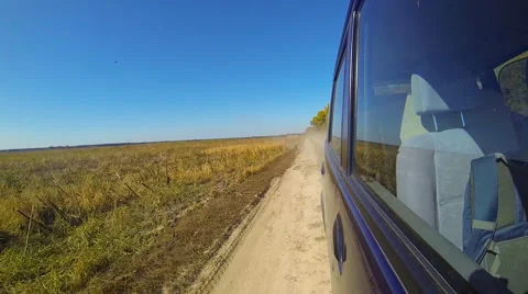 Fast driving a car in the countryside. The camera is outside and aimed back. Stock Footage 44919792