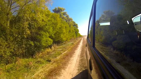 Fast driving a car in the countryside. The camera is outside and aimed back. Stock Footage 44922314