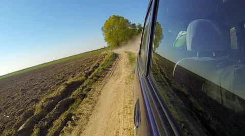 Fast driving a car in the countryside. The camera is outside and aimed back. Stock Footage 49798537