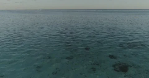 Fast drone flight above turquoise waters of wavy blue ocean of Cook islands. Stock Footage 211710673