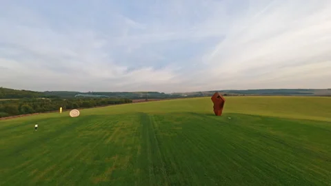 Fast drone fpv flight. Point of view of unusual burgundy sculpture in center of Stock Footage 186125525
