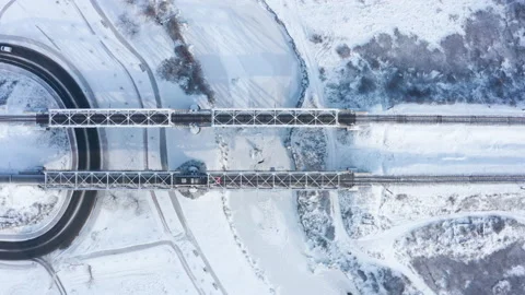 Fast electric train passes over the railway bridge in winter. Stock Footage 147077349
