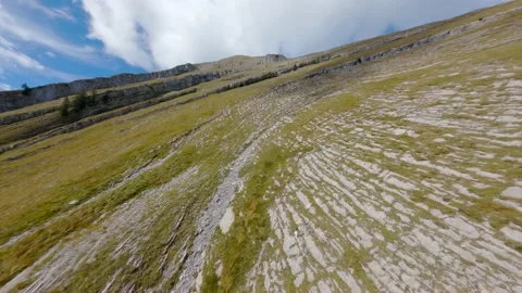 Fast extreme close diving drop down fly steep rocky mountain rock peak slopes Stock Footage 163510592