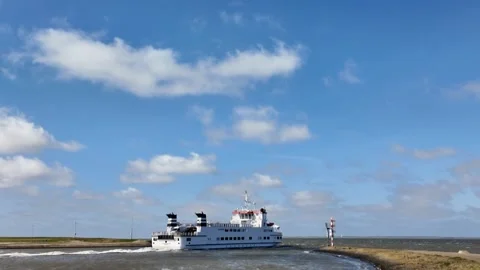Fast ferry boat turning left into open sea leaving Lauwersoog harbor Stock Footage 336406913