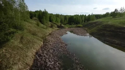Fast flight low above the ground. View of hills and trees. No one around, sunny  Stock Footage 274405075