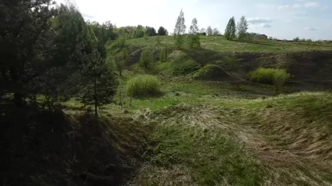 Fast flight low above the ground. View of hills and trees. No one around, sunny  Stock Footage 274405080