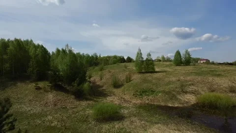 Fast flight low above the ground. View of hills and trees. No one around, sunny  Stock Footage 274405148