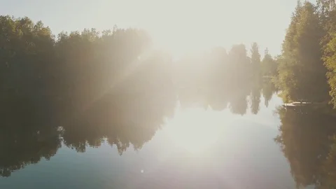 Fast flight over the lake to the broken bridhe, sun leaks Video stock 77735167